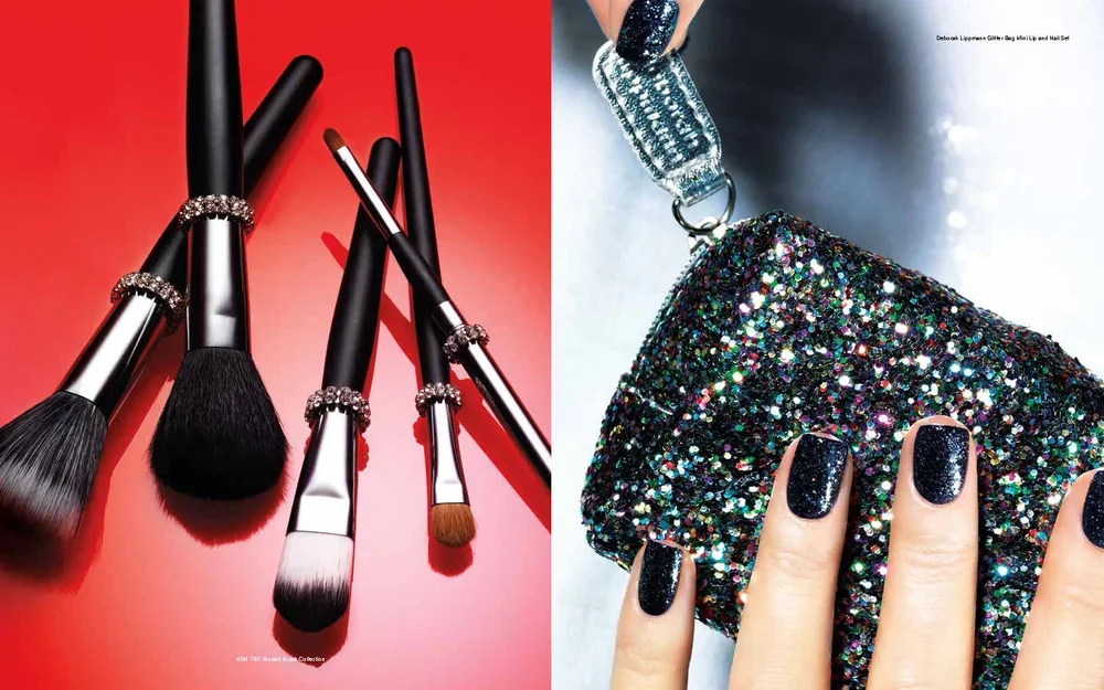 A set of five makeup brushes with black handles and sparkling rhinestone rings, arranged on a red background, and a hand holding a glittery clutch with black nail polish on painted nails.
