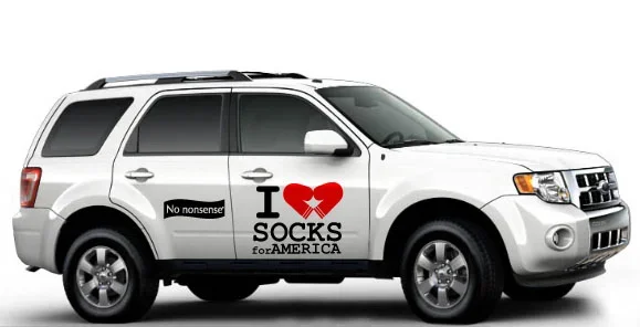 White SUV with political decals including a heart symbol, 'I love socks for America,' and a 'No nonsense!' sticker.