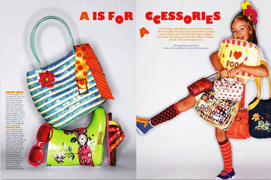 A colorful magazine spread with children's accessories. The left page features a striped blue and white tote bag with an orange strap, a small yellow pouch with a floral pattern, a red pair of sunglasses, and a neon green water toy with a pink bear d
