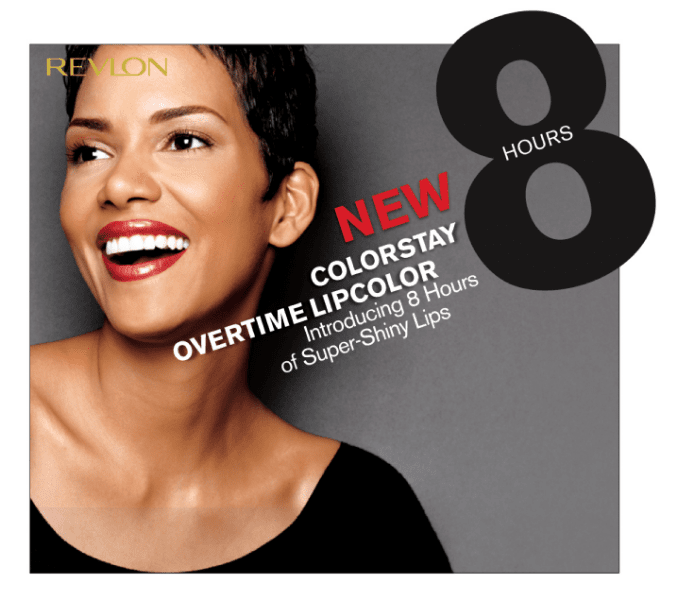 Close-up of a woman with short dark hair, smiling with shiny lips, advertising Revlon lipstick, highlighting 8 hours of long-lasting color.