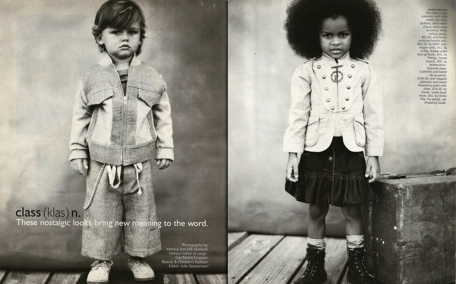 Black and white photo of two young children dressed in vintage clothing, standing indoors on a wooden floor against plain backgrounds. The boy on the left wears a patched jacket, loose trousers, and sneakers, looking serious. The girl on the right ha