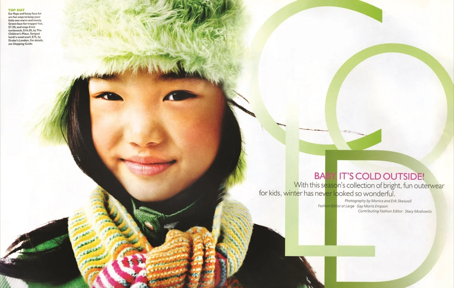 Smiling young girl wearing a fuzzy green hat and colorful striped scarf, looking directly at the camera.