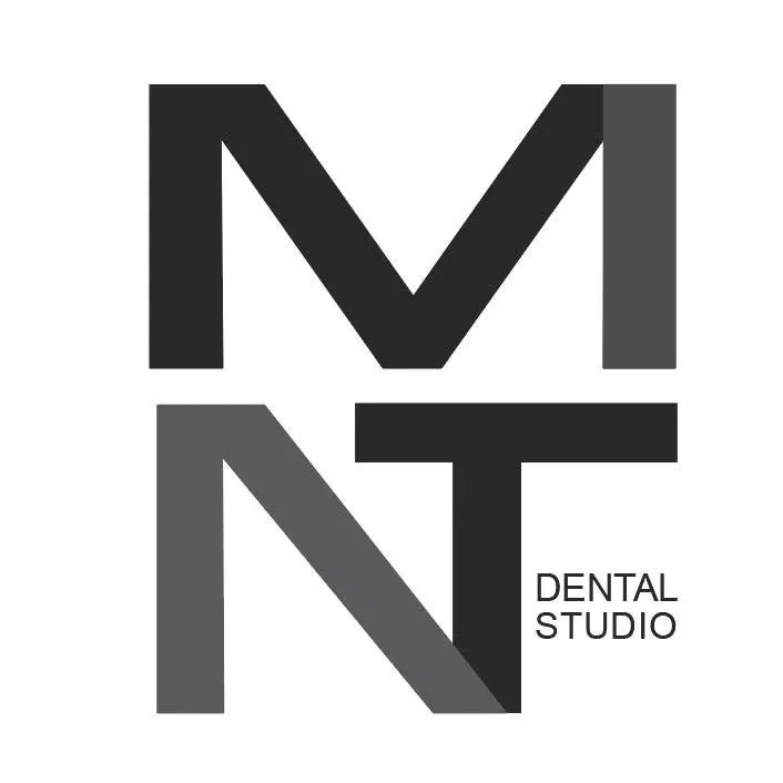 Logo for MNT Dental Studio featuring stylized black and gray initials M, N, T and text.