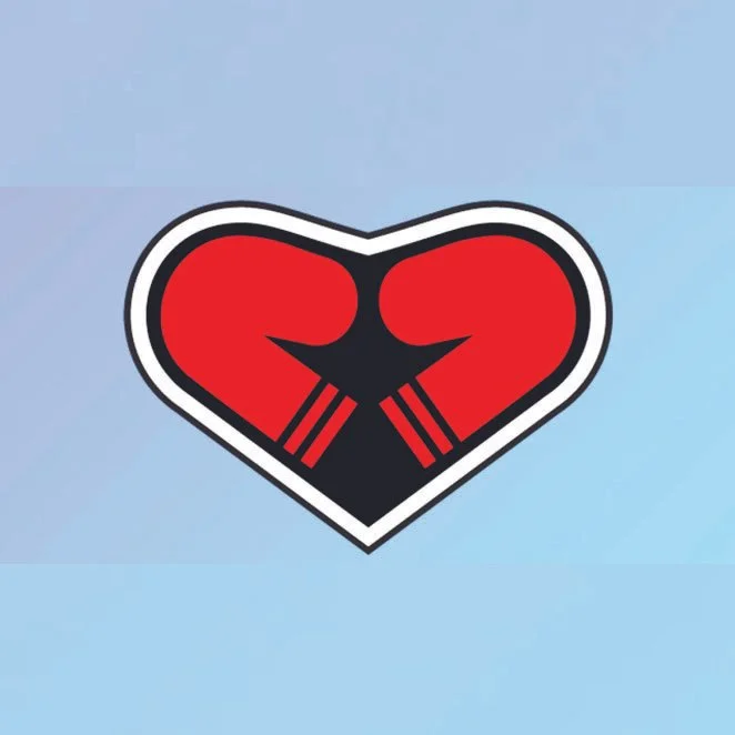 A stylized heart-shaped graphic with a black fist holding two chopsticks inside, set against a light blue background.