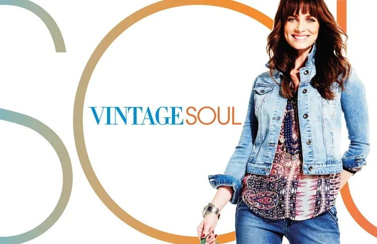 A woman wearing a denim jacket and patterned blouse standing in front of a modern background with circles and the words "VINTAGE SOUL" in colorful text.