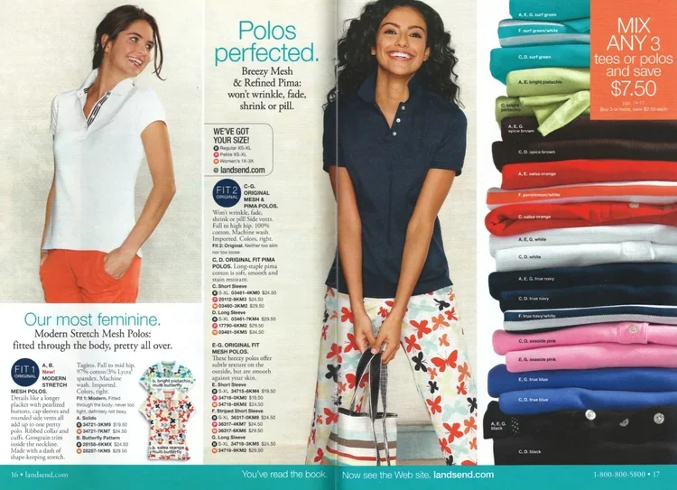 A woman smiling and wearing a white polo shirt with orange shorts, another woman smiling wearing a navy polo shirt with colorful floral pattern shorts, and a display of various colored polo shirts and t-shirts.