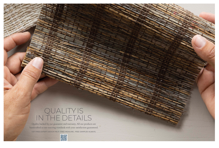Hands holding a rolled bamboo or wooden slat reed blind or mat.