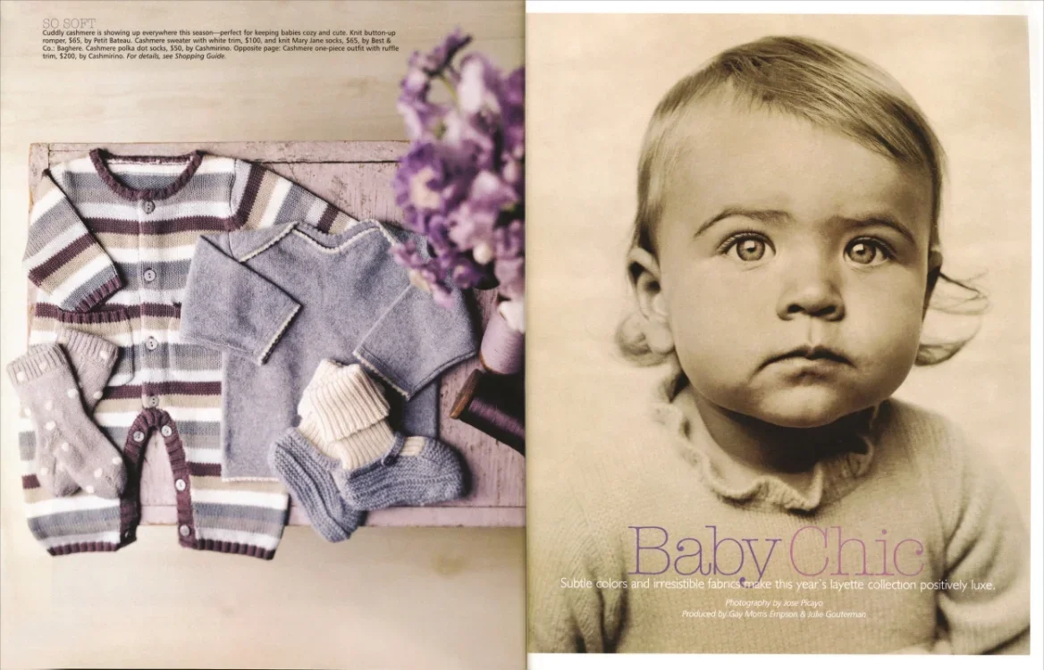 A magazine spread featuring a collection of baby clothes on the left page, including knitted sweaters and socks, and a black-and-white portrait of a young girl on the right page with the caption 'Baby Chic'.