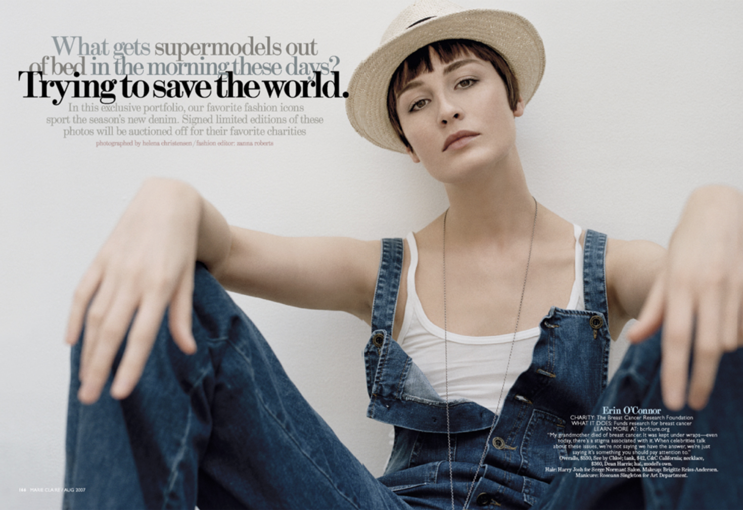 A woman wearing a white tank top, denim overalls, and a straw hat, sitting against a plain white wall, with text overlay about breast cancer research charity and fashion magazine features.