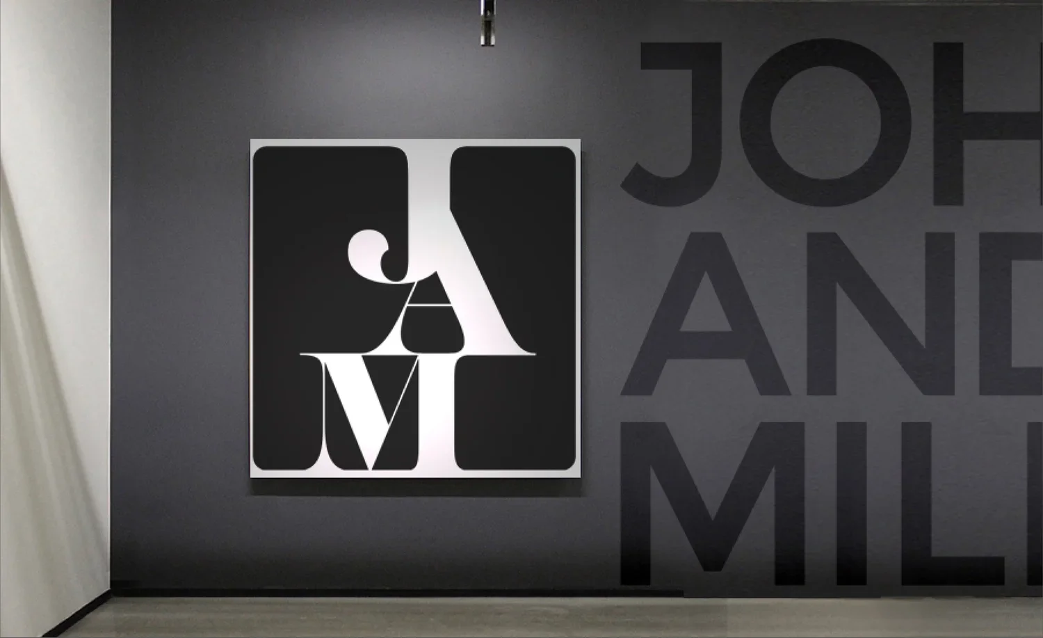 Gray wall with black and white abstract art and partial large black text reading 'JOH' and 'AND'. The art features stylized, overlapping letters in black and white.