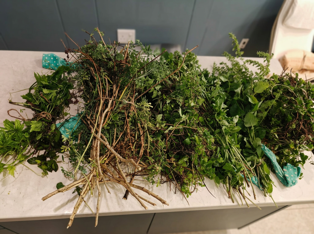 Piles of uprooted garden herbs and plants on a white countertop