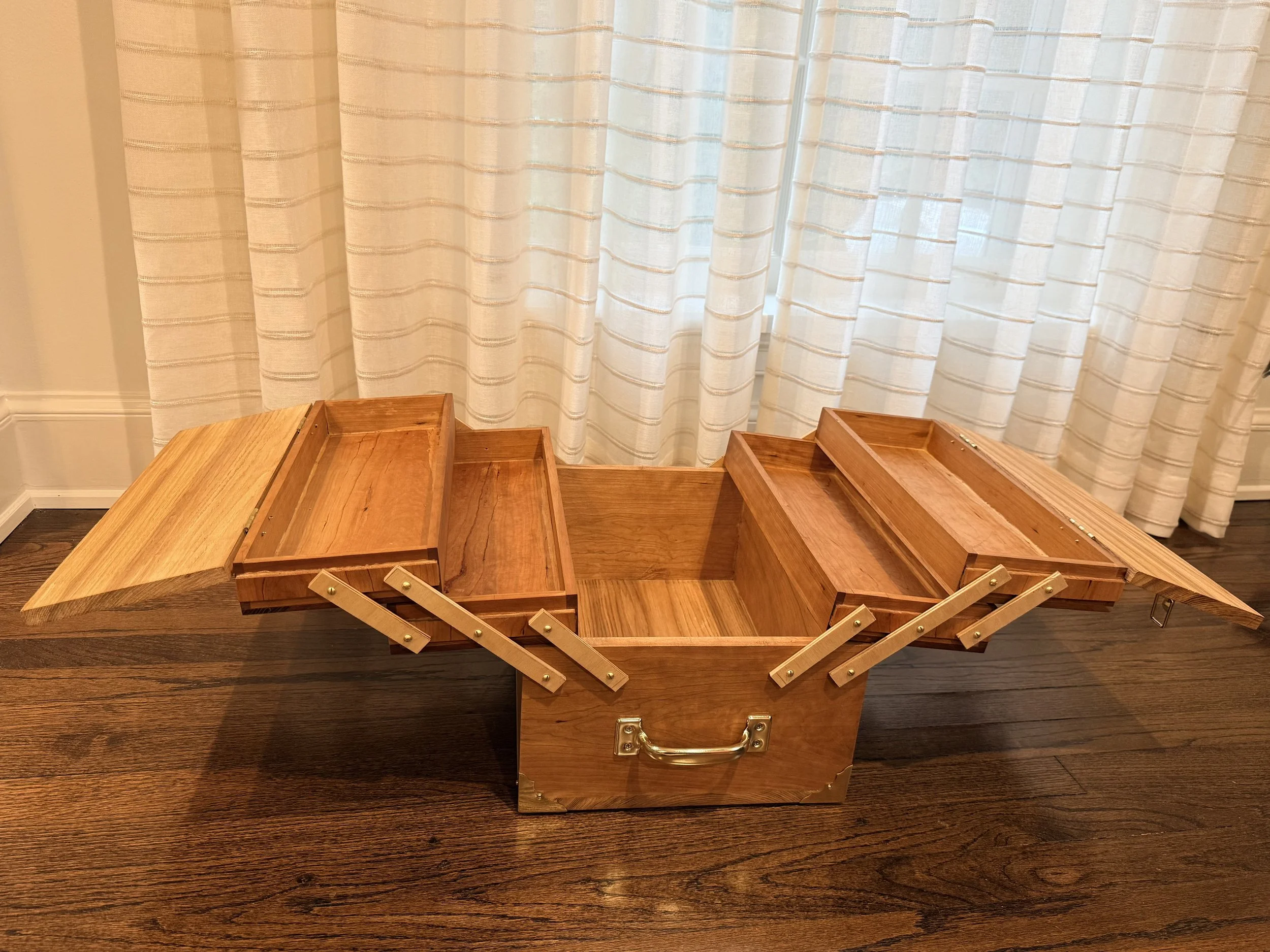 a wooden box with unfolded vertically-stacked shelves