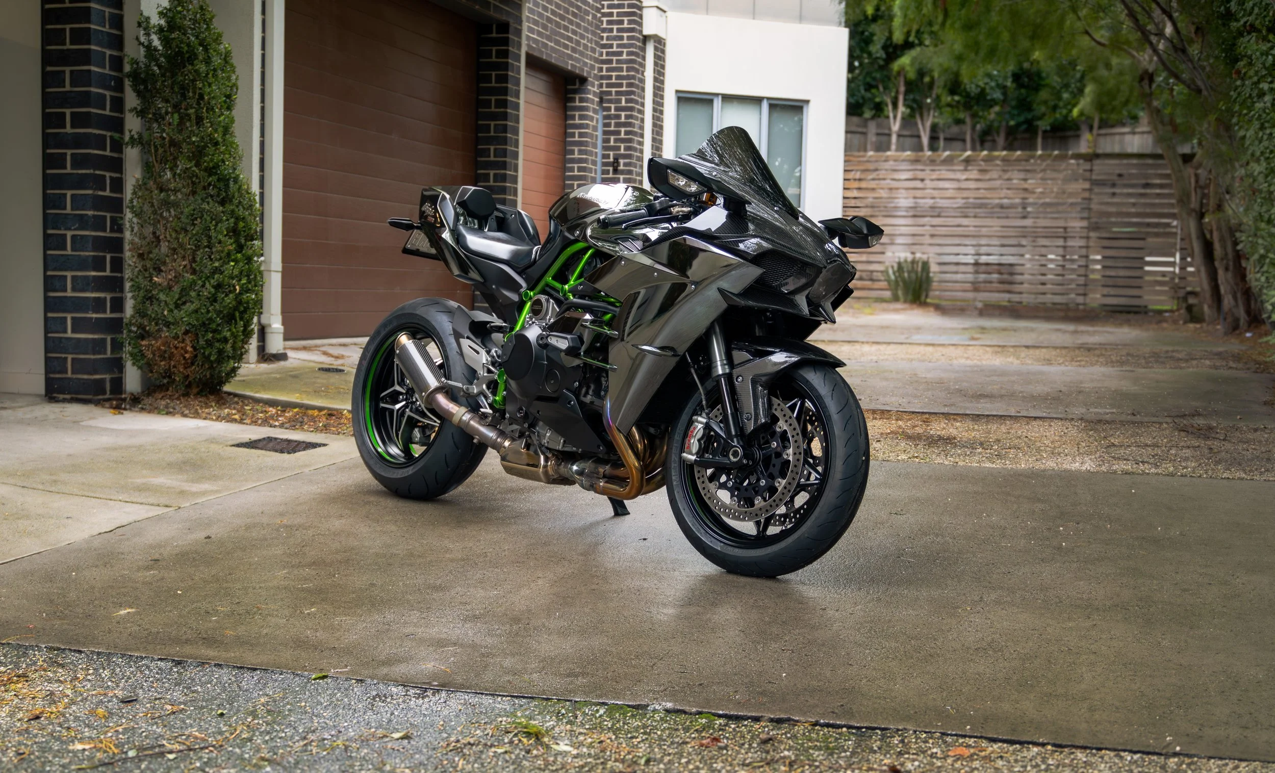 A Kawasaki H2 after paint correction and ceramic coating, parked at Curated - Specialised Detailing's studio.
