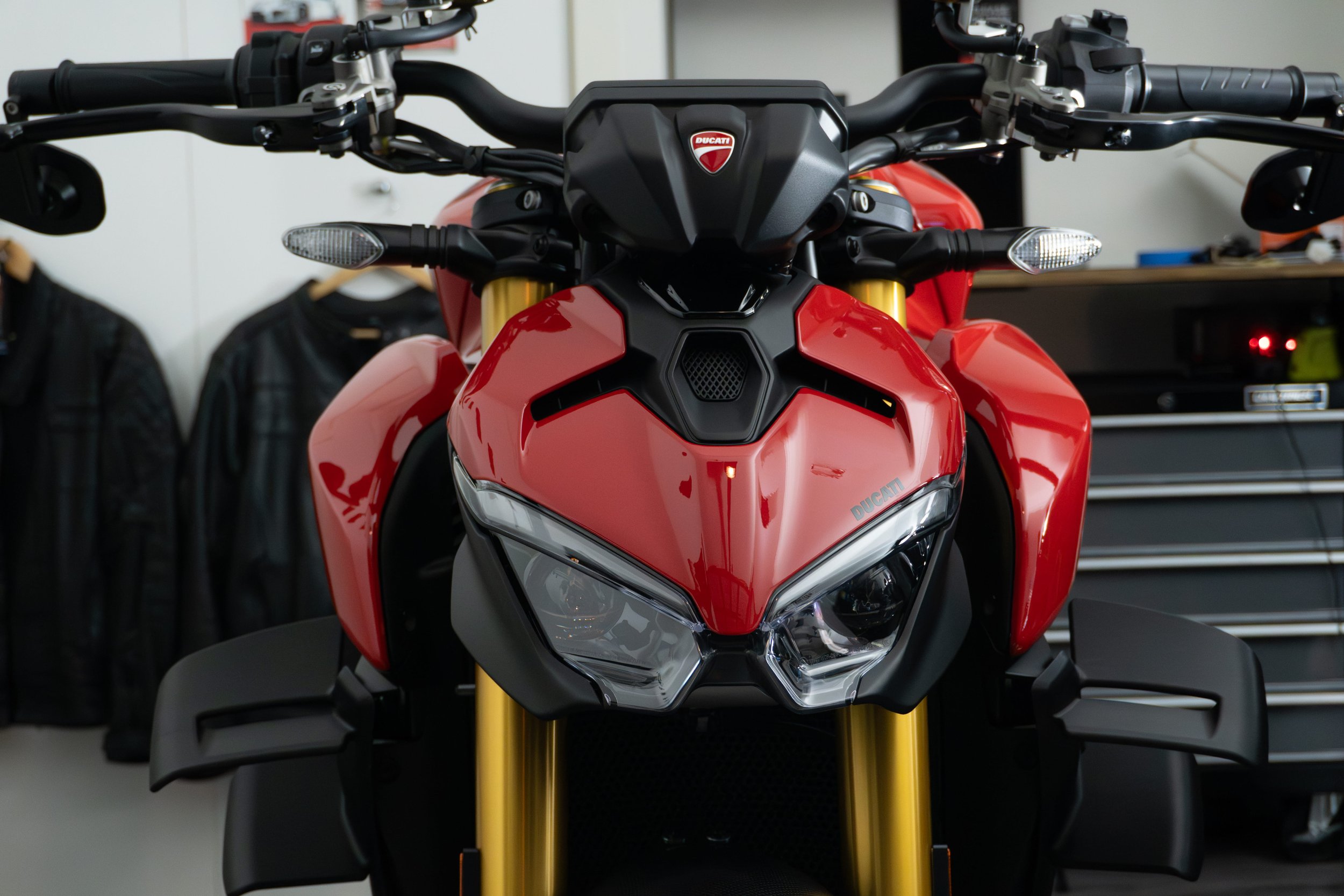Front view of a red Ducati motorcycle in Curated - Specialised Detailing's professional studio.