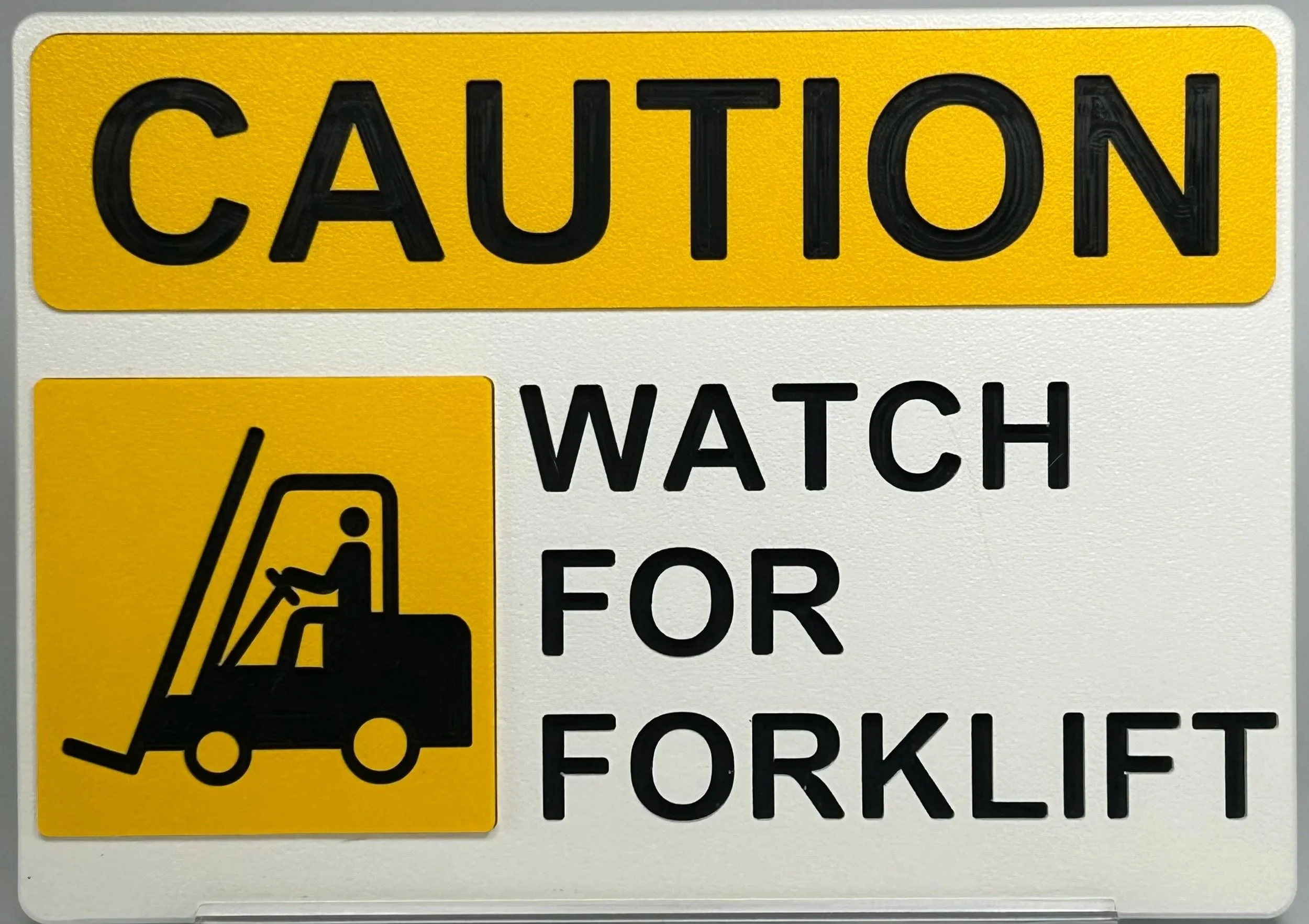 A yellow and black caution sign with an illustration of a forklift and text that reads, 'Caution Watch for Forklift'.