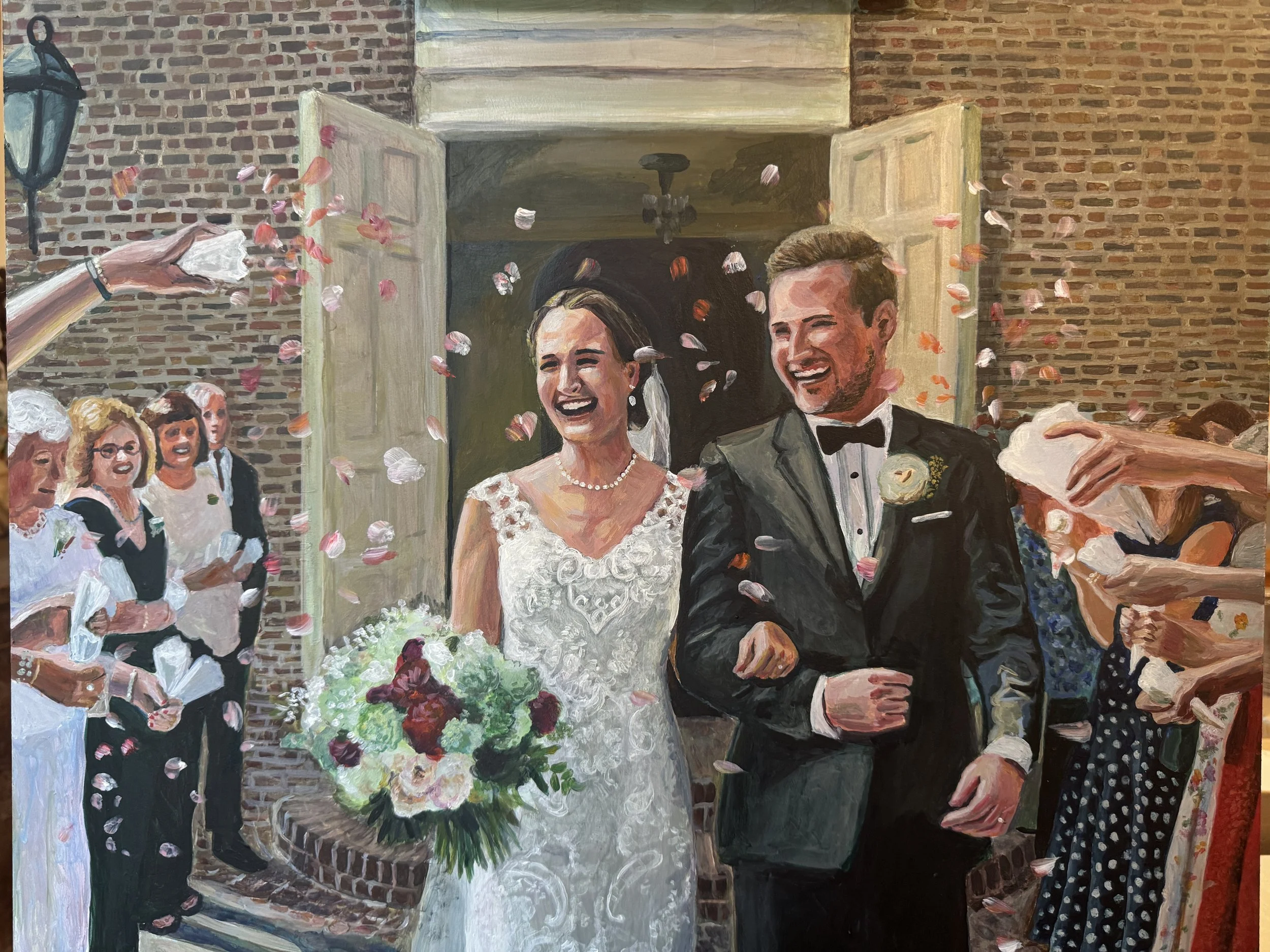 The painting depicts a wedding scene with a bride and groom smiling, surrounded by guests and confetti falling. The bride wears a white lace wedding dress and a pearl necklace, while the groom is in a black tuxedo with a boutonniere. They stand outsi