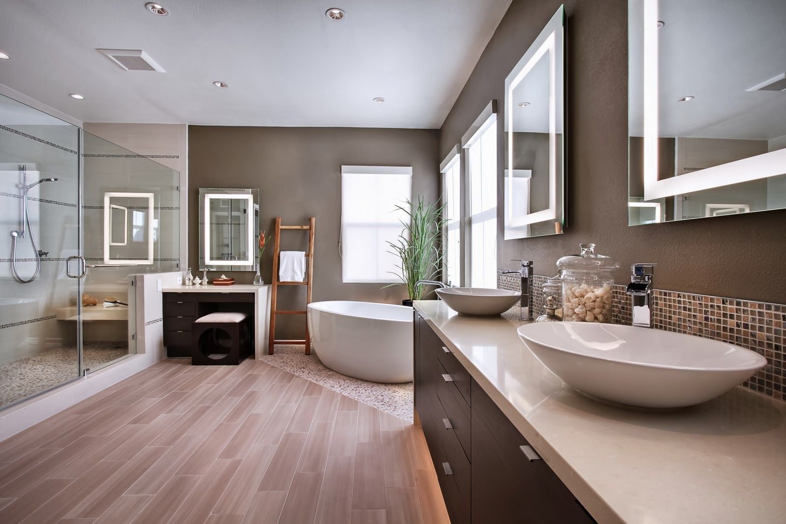 Modern bathroom with a double sink vanity, large mirror, walk-in shower, freestanding bathtub, and natural light from windows.