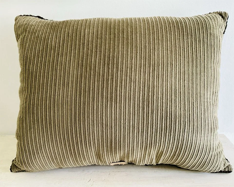 Back of pillow in natural cotton corduroy fabric.