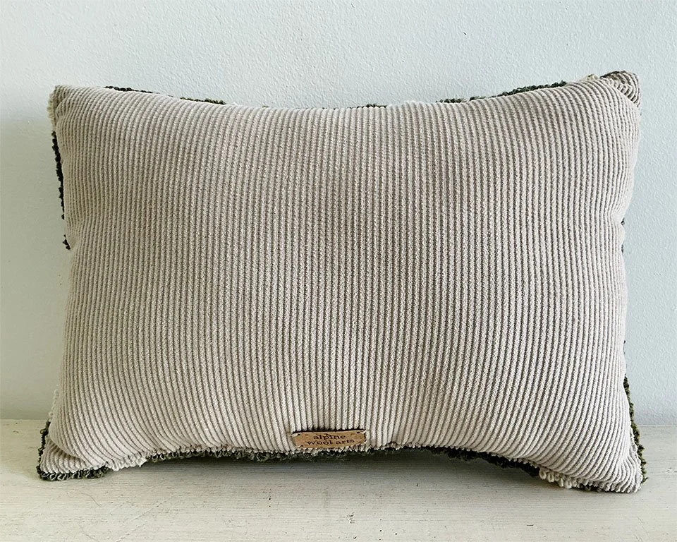 Back of pillow in natural cotton corduroy fabric.