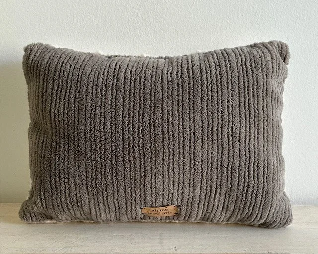 Back of pillow in gray cotton corduroy fabric.