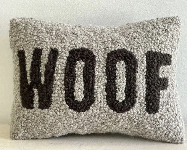 Granite hand-hooked wool pillow with the word "WOOF" in oak brown wool lettering.