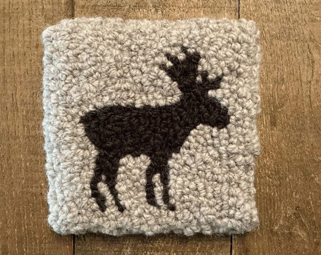 Hand-hooked wool panel featuring moose silhouette on granite wool ground