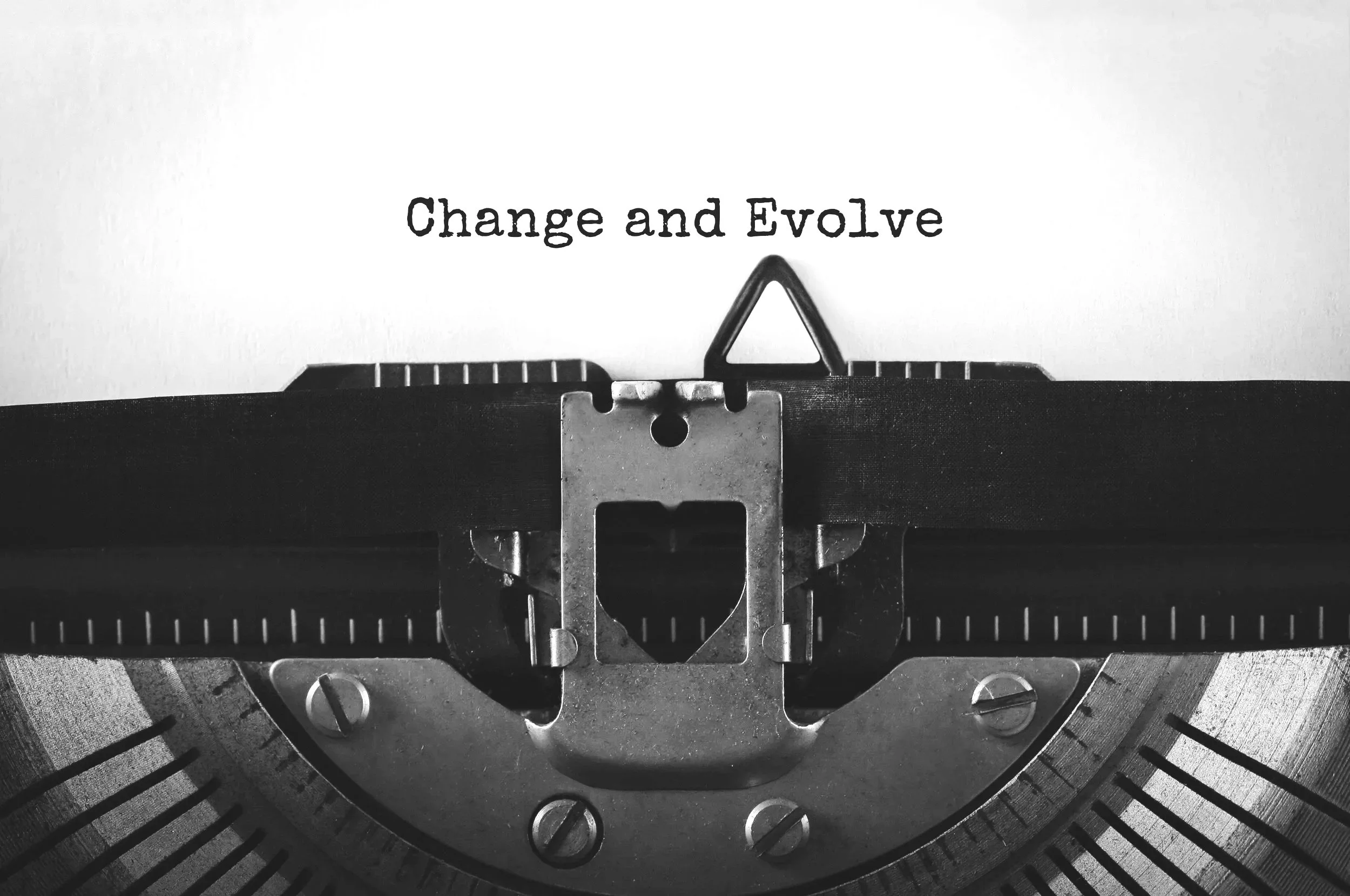 vintage typewriter with the words "Change and Evolve"
