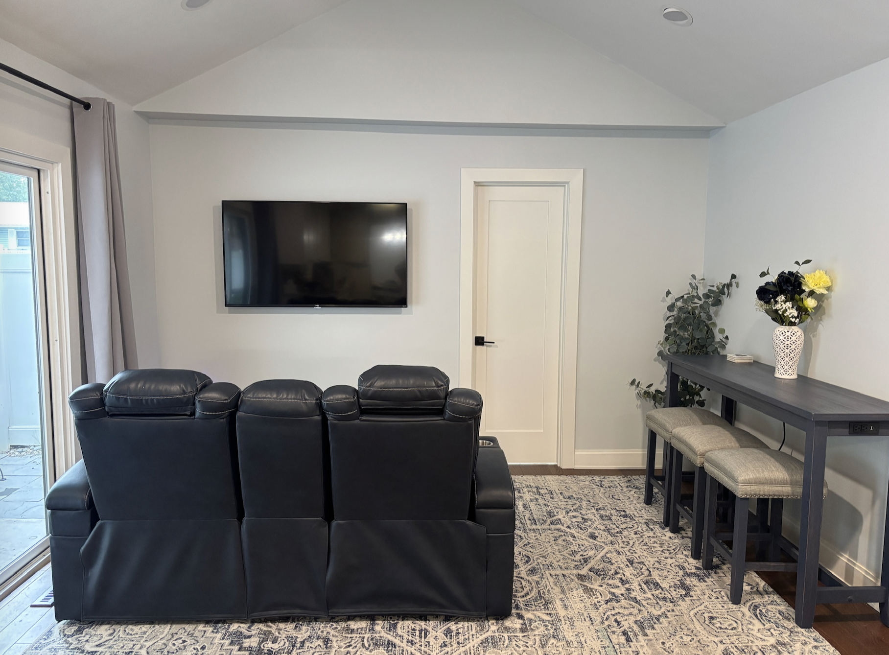 View of den from kitchen featuring navy recliner chairs 
