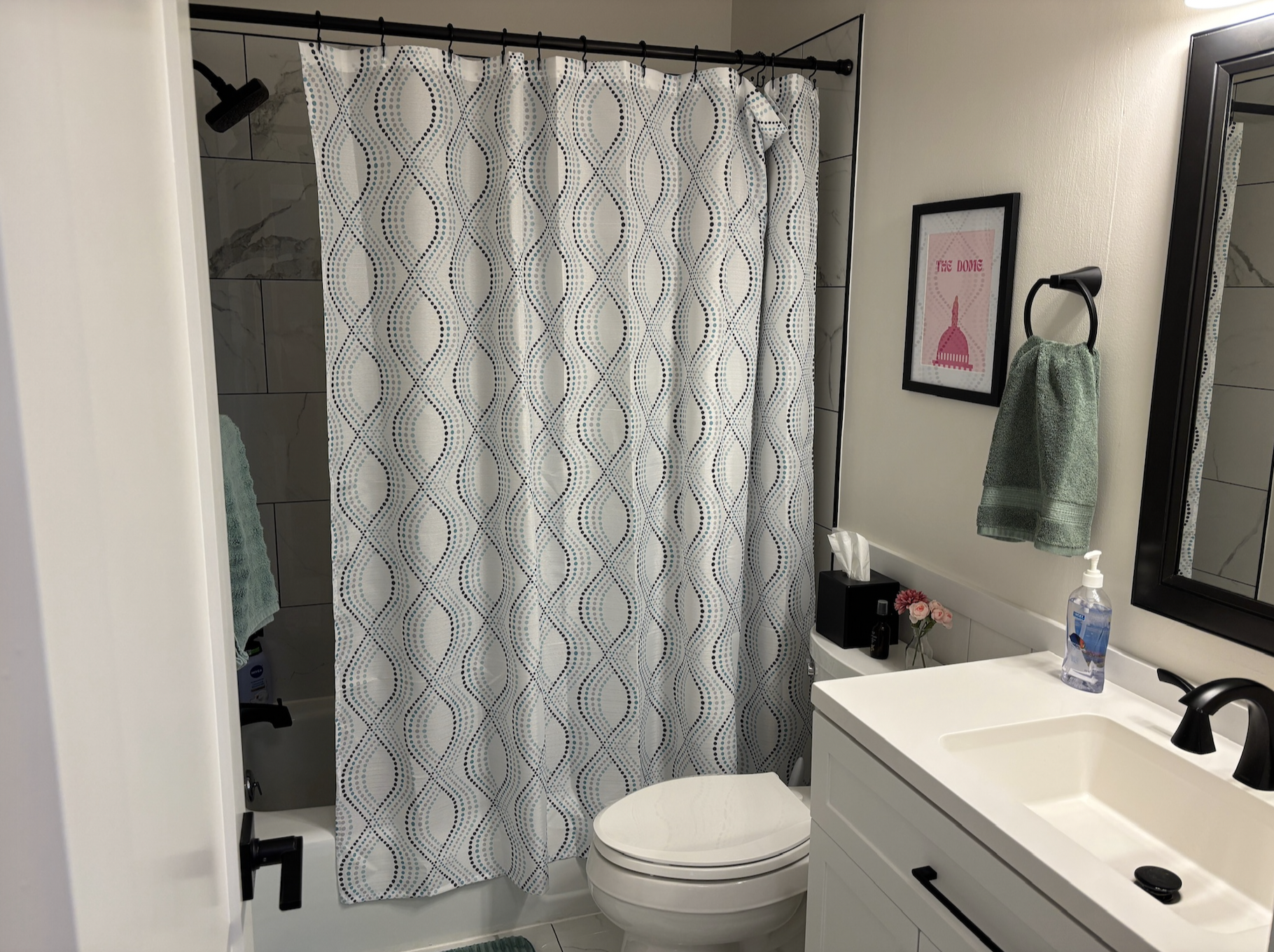 Bathroom near bedrooms featuring tiled shower