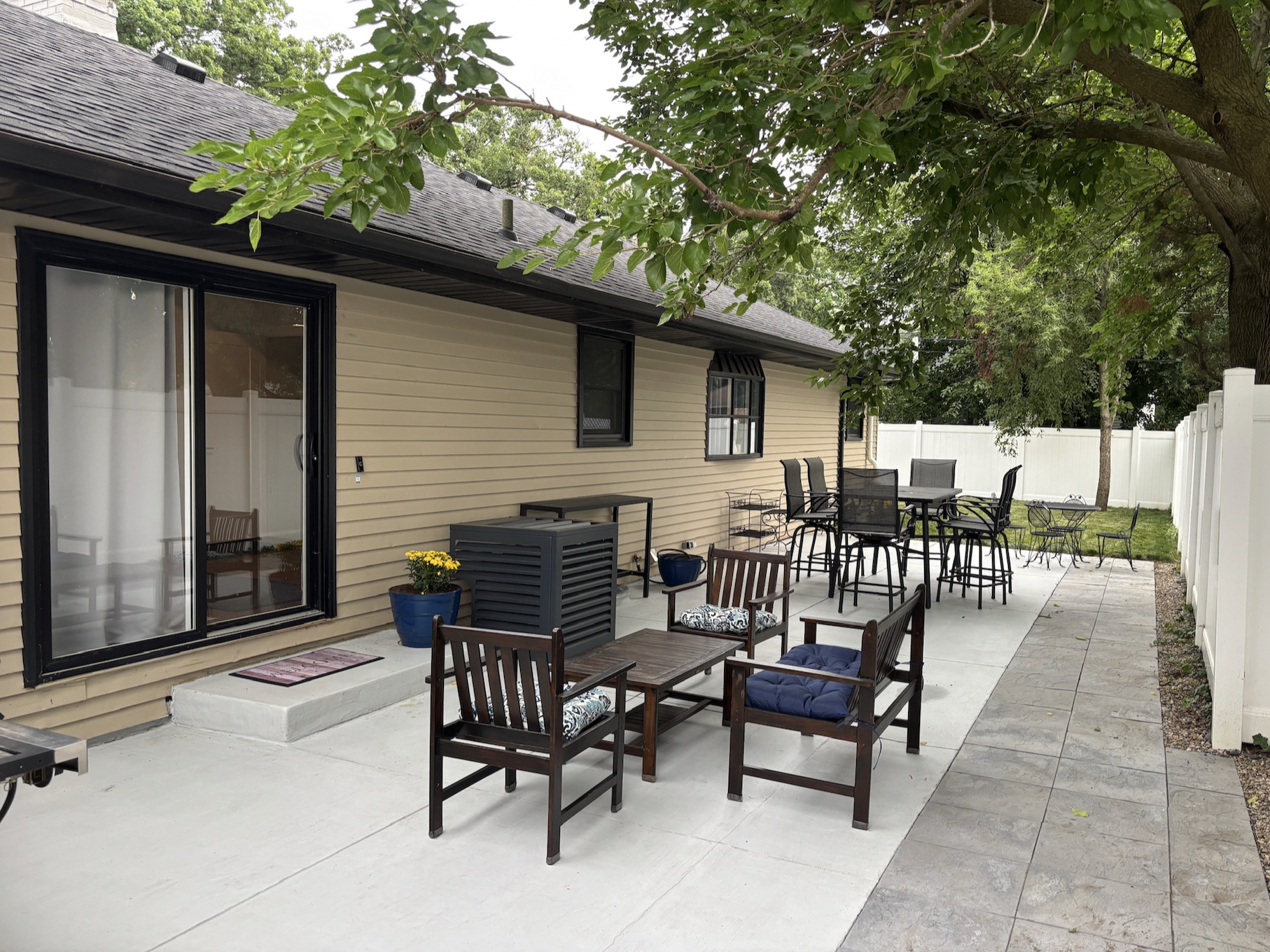 Back patio with two sets of table and chairs