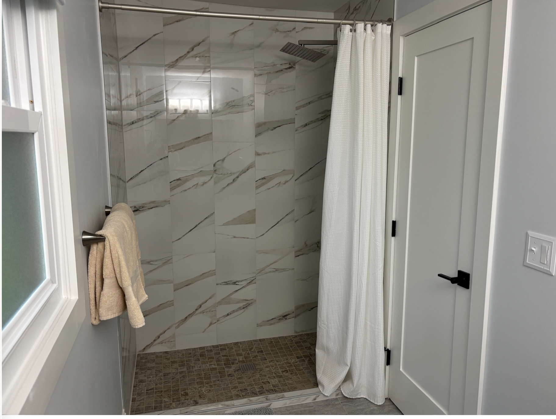 Main hosting bathroom fully tiled shower