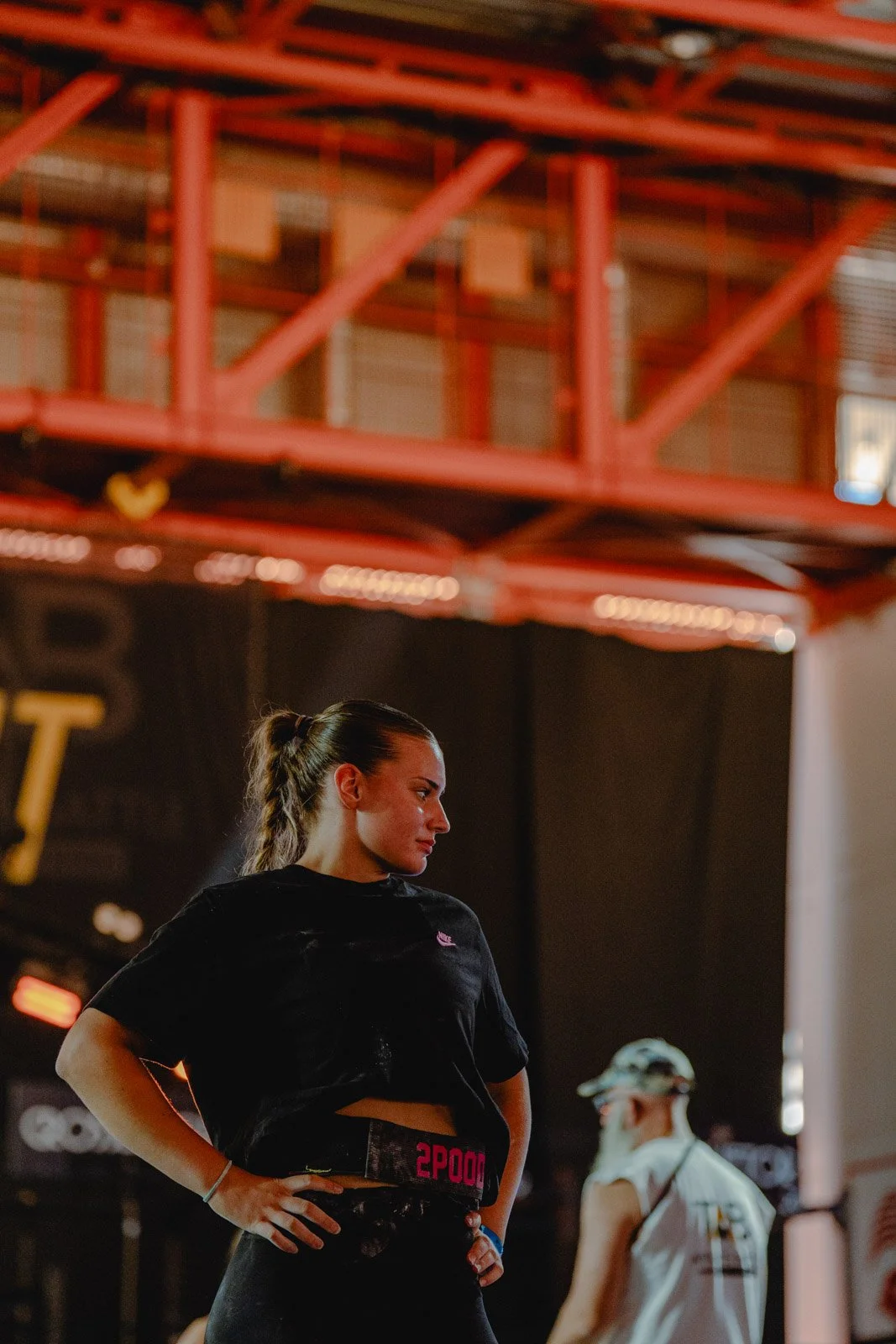 Femme en t-shirt noir sous structure métallique rouge dans une salle CrossFit à Bordeaux — photographe CrossFit Voar by Tim