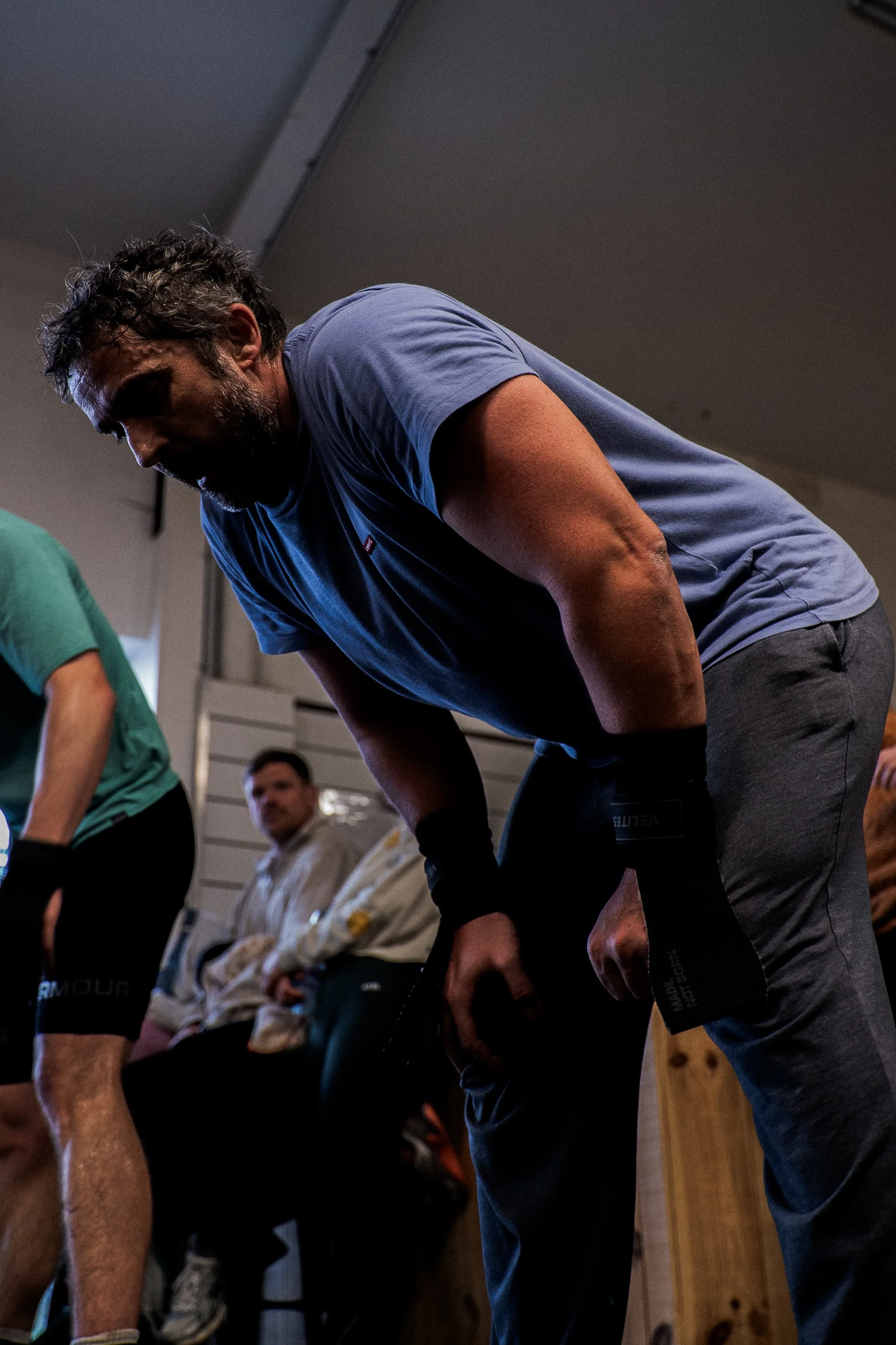 Groupe de personnes assises et en train de faire des étirements ou des exercices, dans une salle intérieure