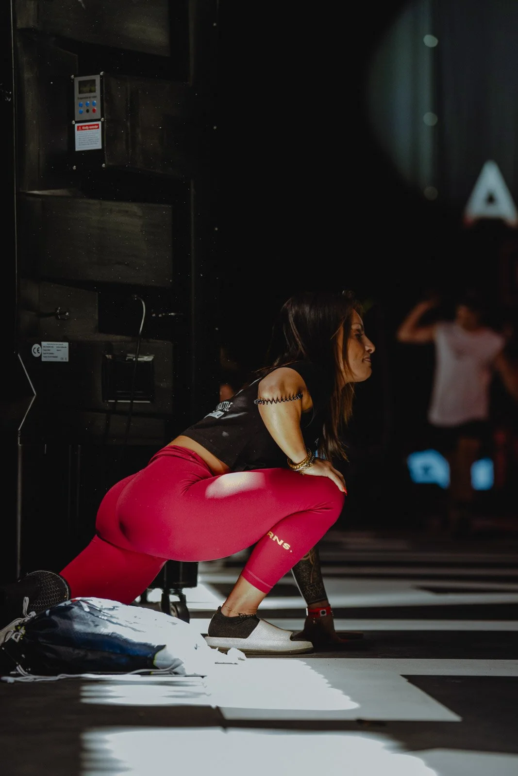 Femme accroupie sur passage piéton en pantalon rouge, lifestyle fitness à Bordeaux — photographe running Voar by Tim