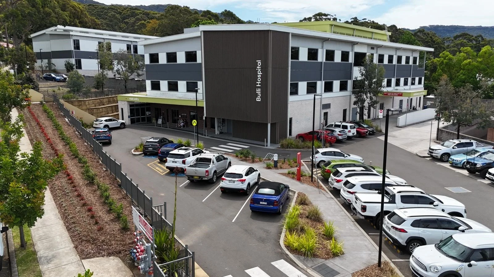 Hospital building with surrounding parking and landscaped grounds