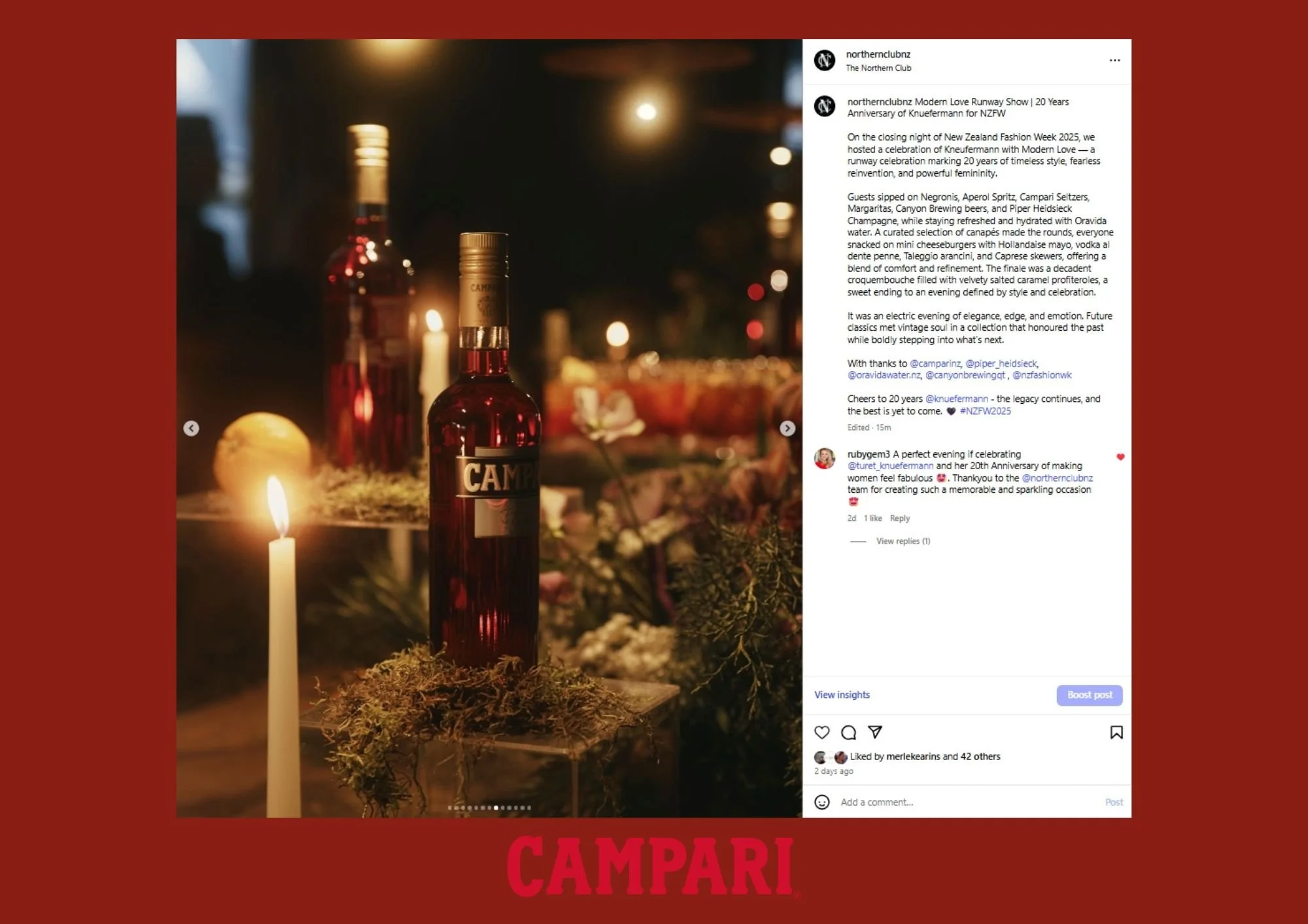 A dimly lit indoor setting with a bottle of Campari in the foreground, illuminated by candles and warm lighting, with blurred background decor and flowers for a celebratory atmosphere.