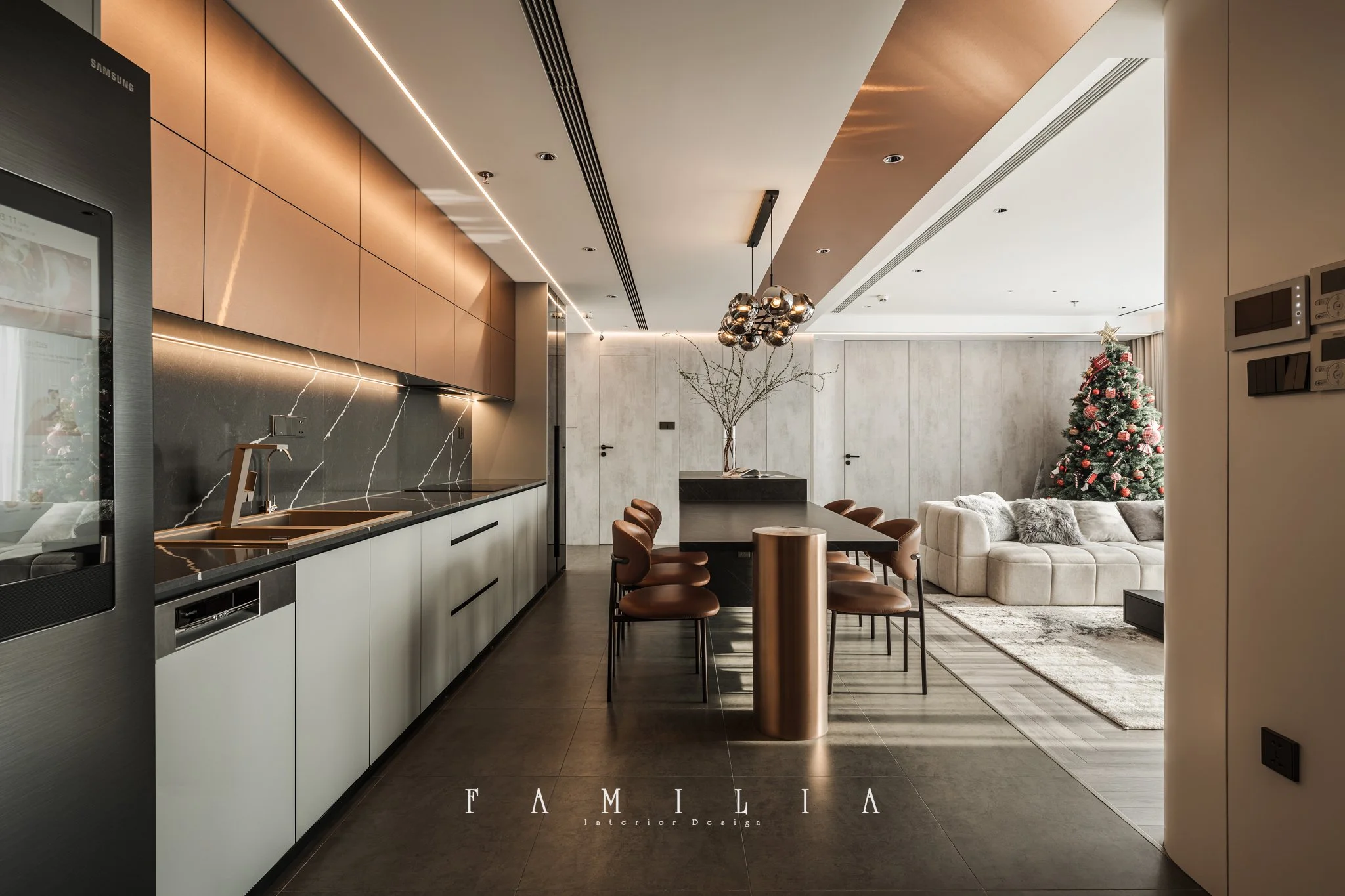 Modern kitchen and living room interior with beige cabinets, black marble countertops, a dining table with brown chairs, a cozy beige sofa with pillows, a decorated Christmas tree with ornaments and a star on top, and minimalistic lighting.