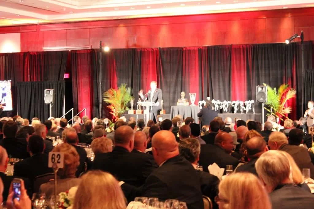 Guests gathered for a live fundraising auction during a formal benefit gala.
