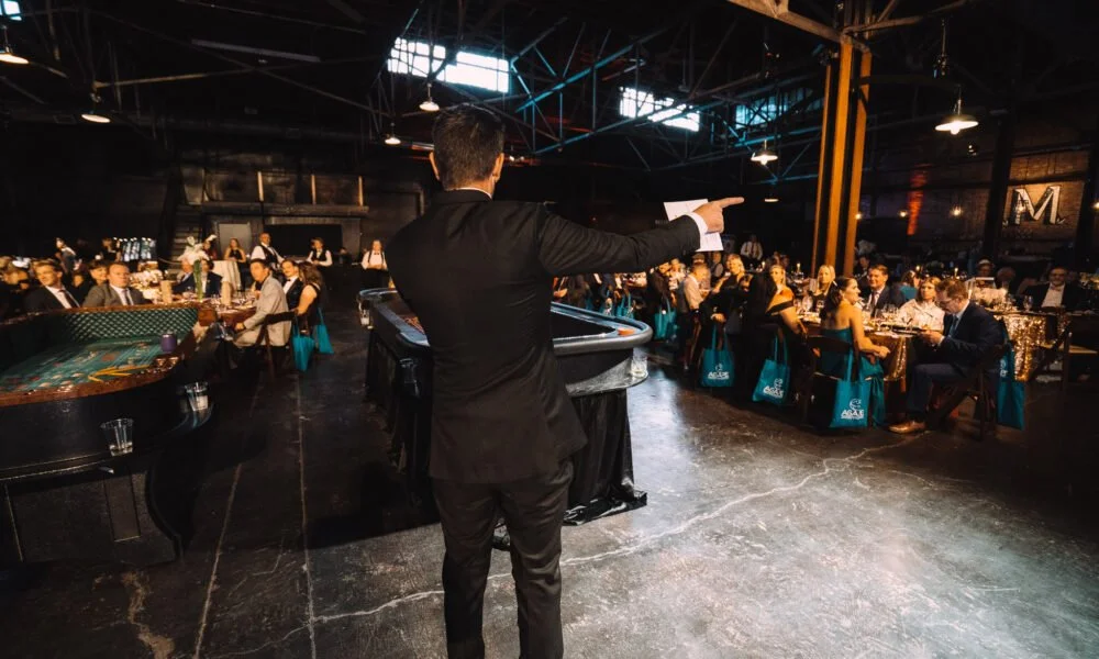 Auctioneer engaging guests during a live fundraising auction.
