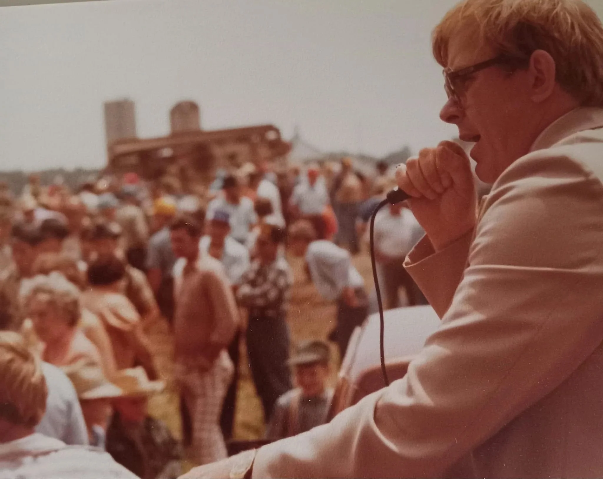 Auctioneer David A. Norton conducting an outdoor auction, part of a career spanning more than forty years in the auction profession.