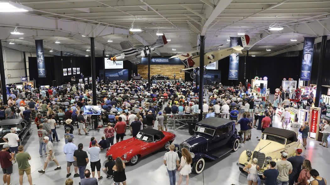 A packed collector-car auction showcasing the scale and energy of the live auction experience.