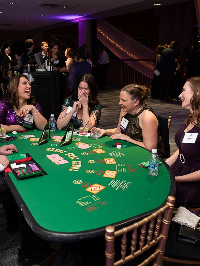 Guests enjoying a casino-themed fundraising event and charity auction.