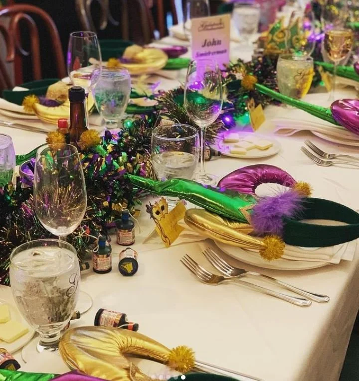 Mardi Gras-themed benefit auction featuring festive décor and an immersive guest experience.