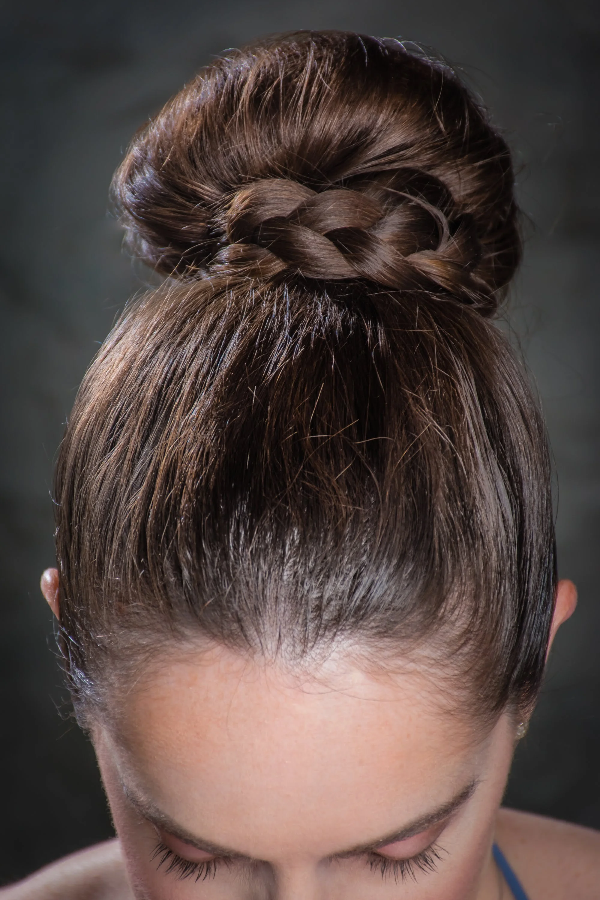  The bridesmaid had thick shoulder length hair. I created a sock-bun and then wrapped a braid from her own hair around the bun to create a classic wedding and bridesmaid hairstyle 