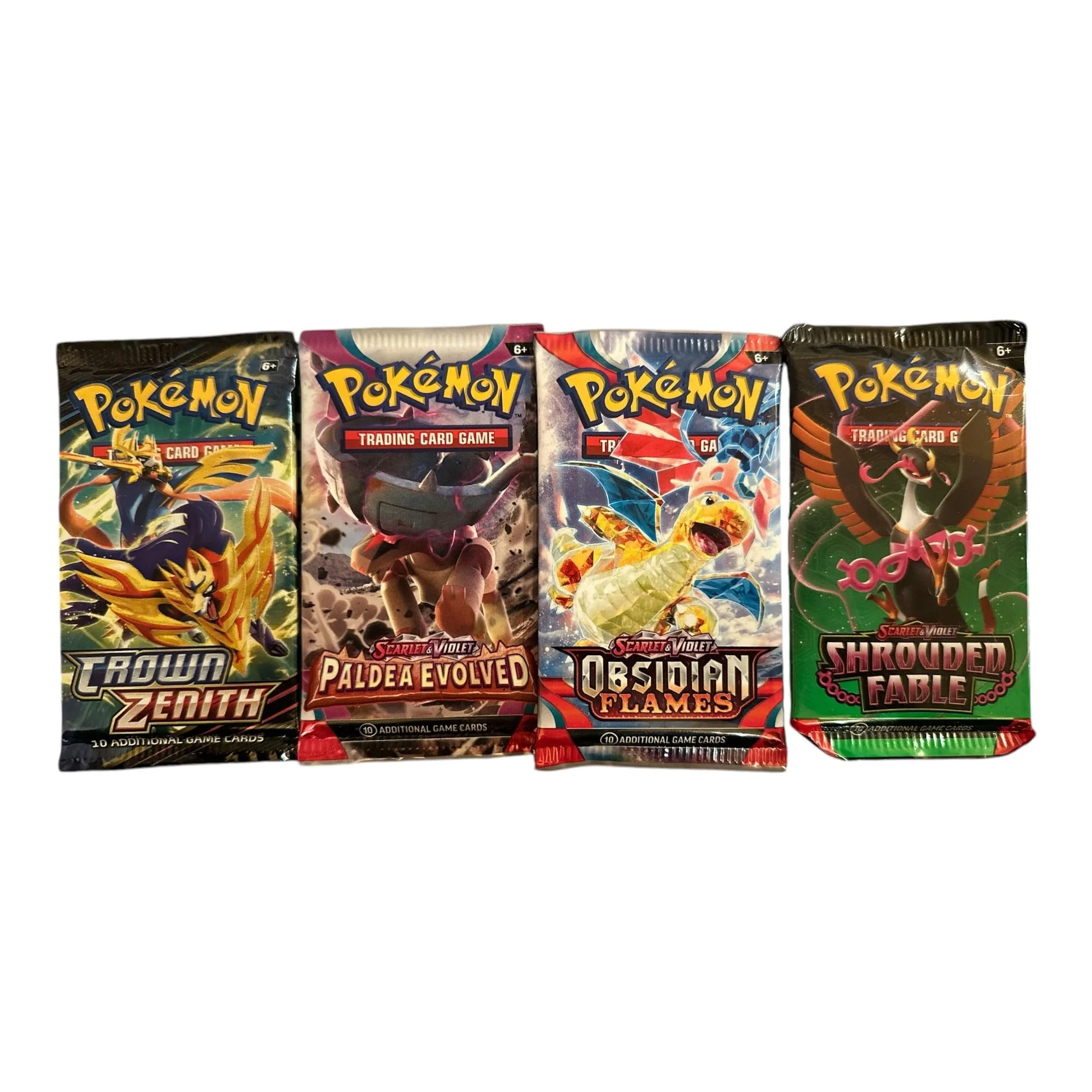 Four Pokémon trading card booster packs arranged side by side with Pokémon illustrations on the packaging.