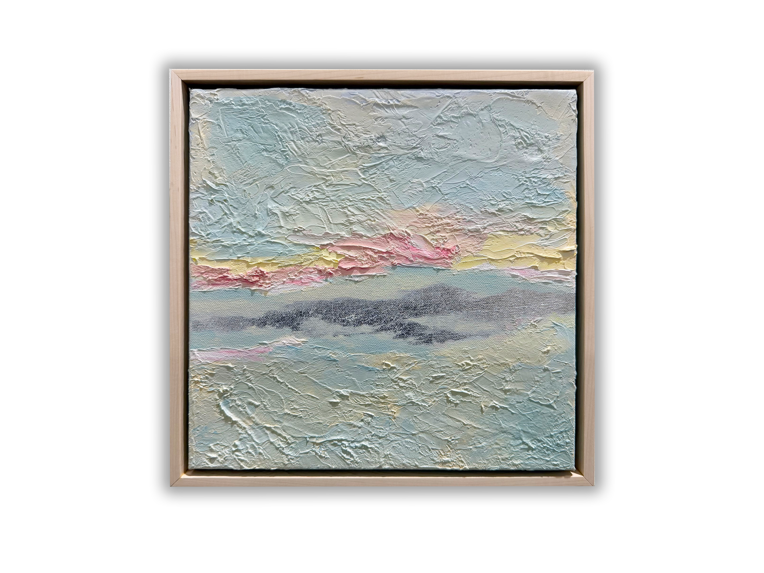 A textured landscape painting with pastel colors, framed in a light wooden frame.
