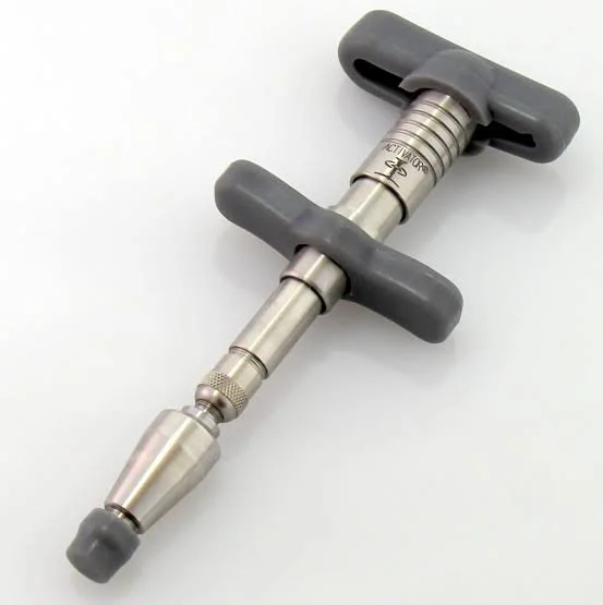 A metal T-handle torque wrench with gray rubber grips and a knurled adjustment knob.