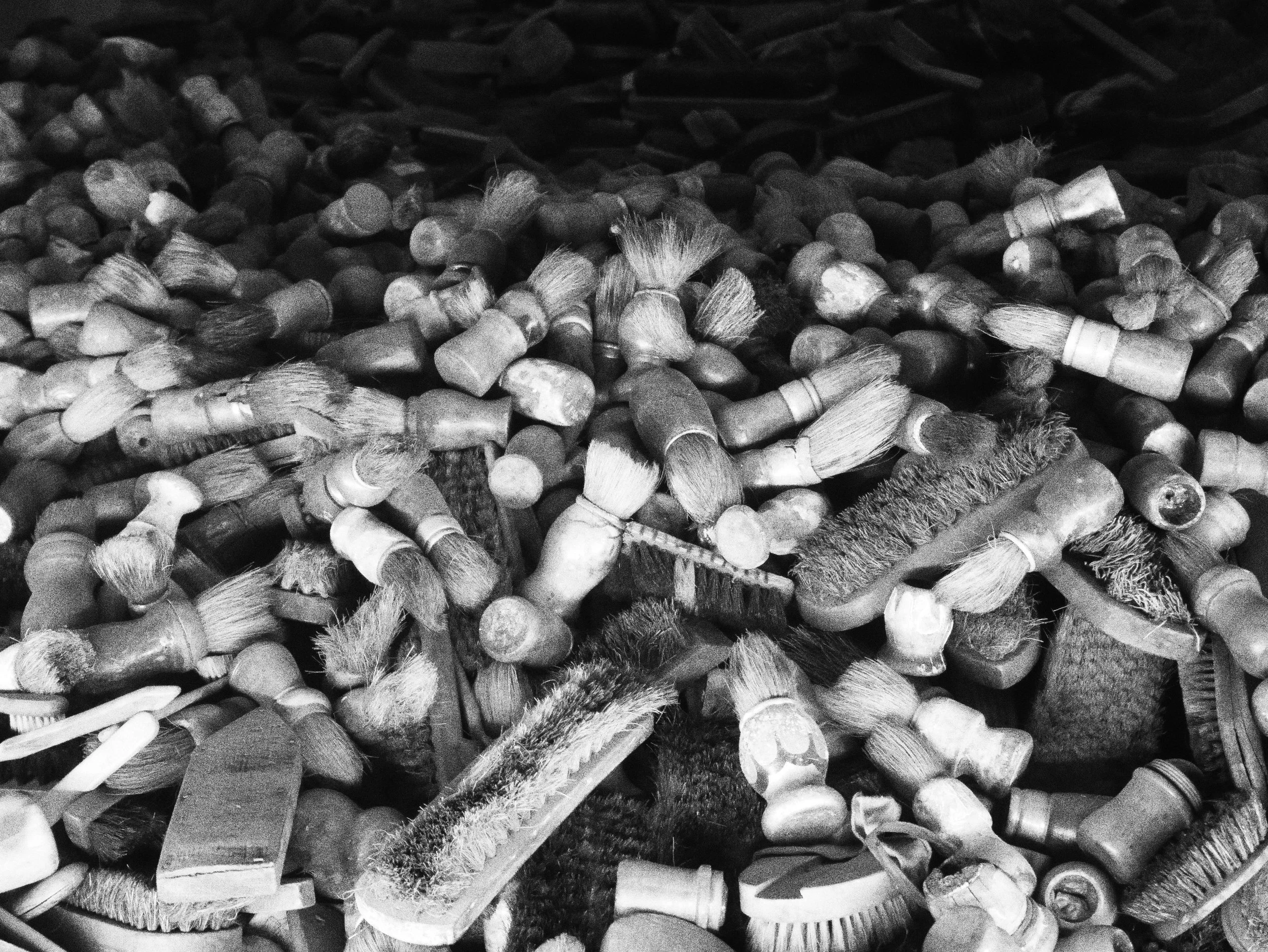 A collection of various paintbrushes and tools scattered across a surface.