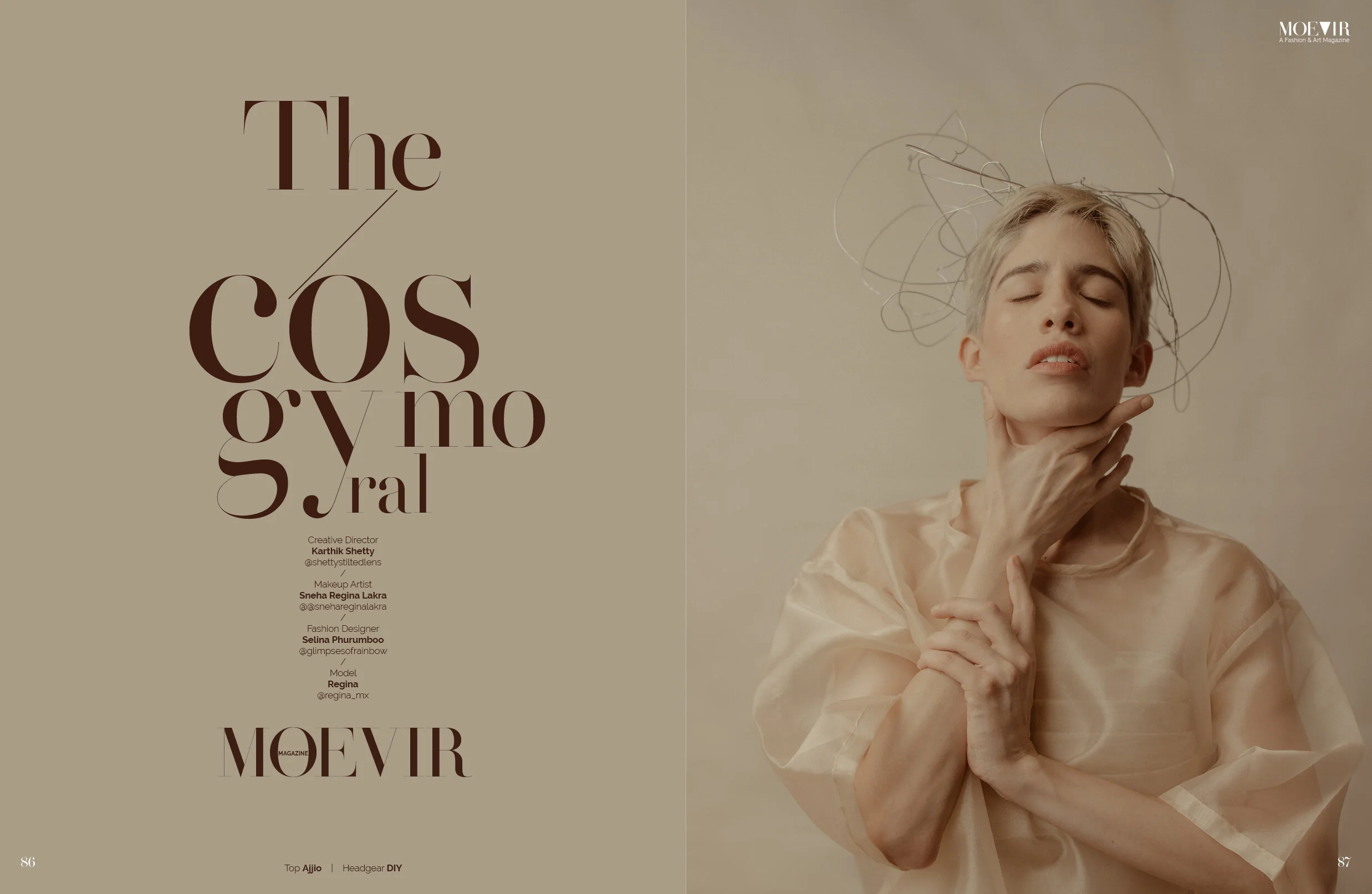 A woman with short blond hair and closed eyes, wearing a beige satin dress, is posing with her hand touching her neck and chin. She has wire-like hair accessories above her head. The background is neutral, and the style appears artistic and editorial