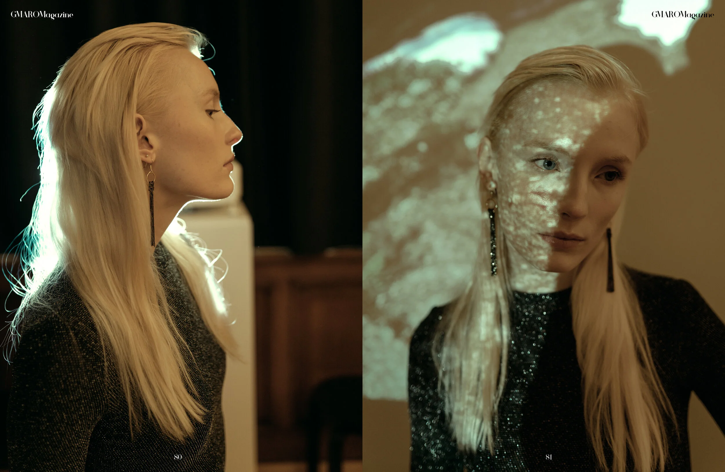 Side profile of a young woman with long blonde hair wearing gold earrings and a black, sparkly top, with a dark background on the left and a pattern of light and shadow on her face from a projected image on the right.